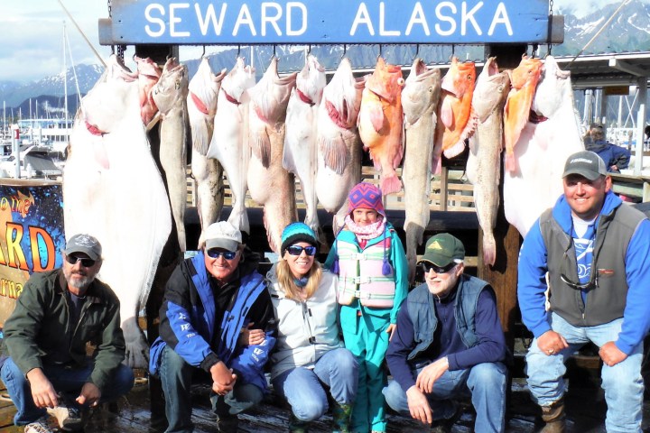 a group of people standing in front of a fish